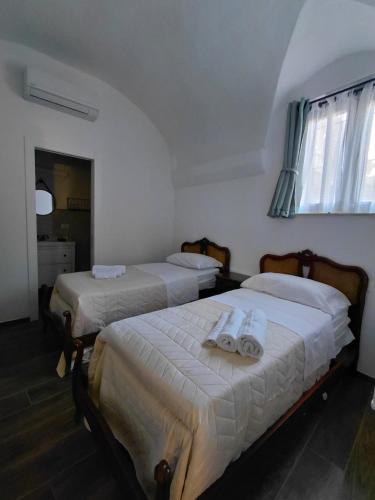 a bedroom with two beds with towels on them at La Ginestra in Bastia