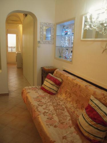 a living room with a couch with two pillows on it at Casa Santiago in Alassio