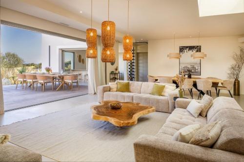 a living room with a couch and a table at Villa Yaya in Cervione