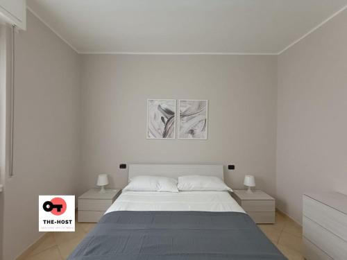 a white bedroom with a bed and two night stands at Vimodrone, modern accommodation near San Raffaele in Vimodrone