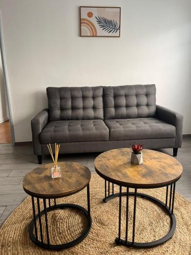 a living room with two tables and a couch at Oasis en La Condesa in Mexico City