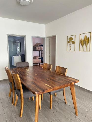 a wooden table and chairs in a room at Oasis en La Condesa in Mexico City