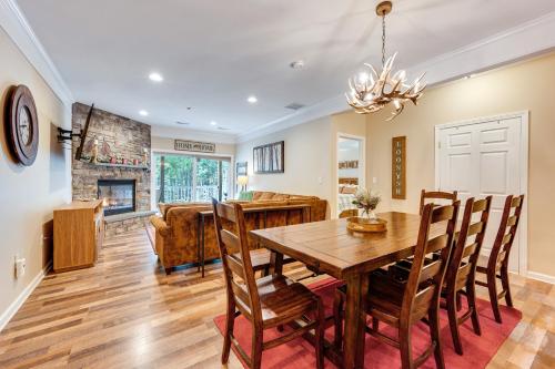 a dining room and living room with a wooden table and chairs at Relaxing Lincoln Condo with Fireplace and Shuttle in Lincoln