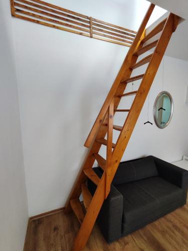 a staircase in a room with a couch underneath it at Duplex Central Eitorf in Eitorf