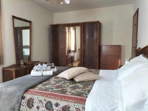 a bedroom with a large bed with pillows on it at Appartamento l'angelo in Predazzo