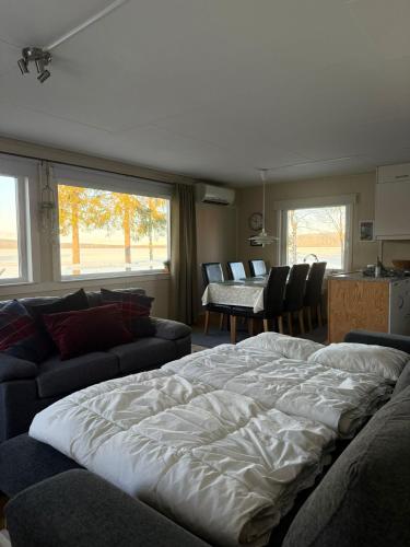 a bedroom with a large bed and a living room at Camp Caroli Family House in Jukkasjärvi