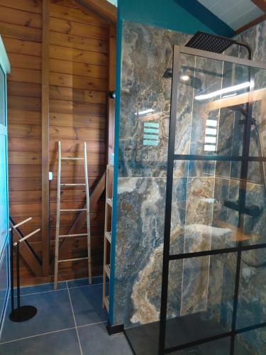 a room with a sauna with a glass door at Bungalow Capucine in Capesterre-Belle-Eau