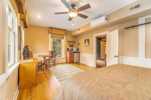 a bedroom with a bed and a ceiling fan at Cozy Cub Den in Bryson City