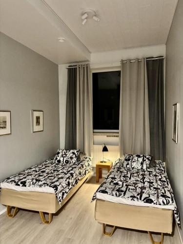 two beds sitting next to each other in a bedroom at Inari Camping & Resort in Inari