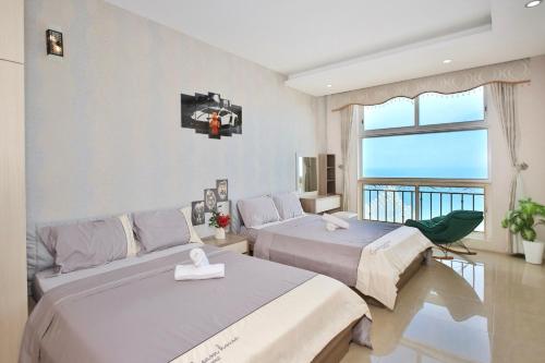 Ένα ή περισσότερα κρεβάτια σε δωμάτιο στο Căn hộ OASKY ngay Tháp Tam Thắng