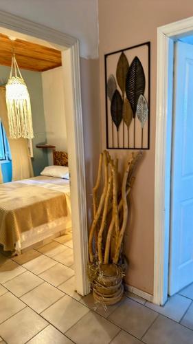 a bedroom with a bed and a vase with leaves on the wall at Meduza in Mesochórion