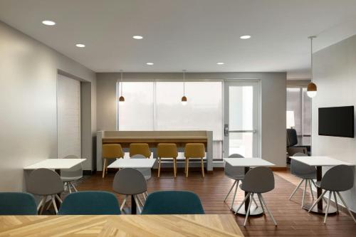 a conference room with tables and chairs and a table at TownePlace Suites by Marriott Pittsburgh Harmarville in Harmarville