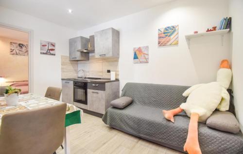 a living room with a couch with a stuffed animal on it at Lovely Home In Civitavecchia in Aurelia
