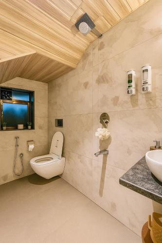 a bathroom with a toilet and a sink at 3 BHK Mount Villa by Asmeera Stays in Lonavala