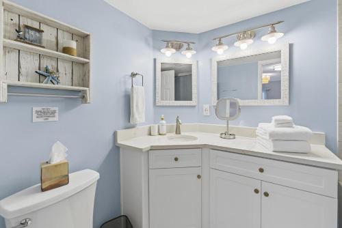 a white bathroom with a sink and a toilet at Bermuda Run 10 in Saint Augustine Beach