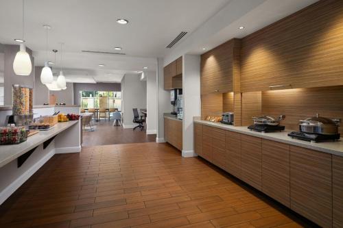 a kitchen with wooden cabinets and a counter top at TownePlace Suites by Marriott Phoenix Chandler/Fashion Center in Chandler