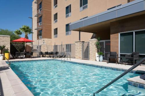 a swimming pool in front of a building at TownePlace Suites by Marriott Phoenix Chandler/Fashion Center in Chandler