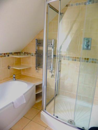 a bathroom with a shower and a bath tub at Basingstoke Apartments - St Raphael House, City Centre Charming Apartments in Basingstoke