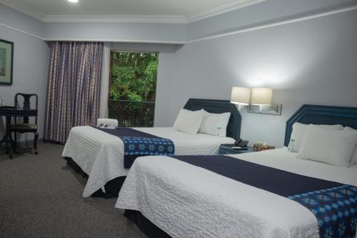 Ένα ή περισσότερα κρεβάτια σε δωμάτιο στο Nk Hotel Nekié Tepic