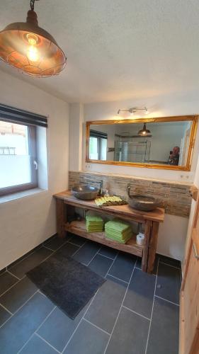 a bathroom with two sinks and a mirror at Chalet Weitsee in Reit im Winkl