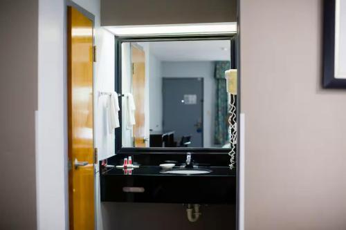 a bathroom with a sink and a large mirror at Townhouse Fort Walton Beach Hurlburt Field in Mary Esther