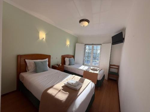 Postel nebo postele na pokoji v ubytování Hospedaria Canto do Rossio