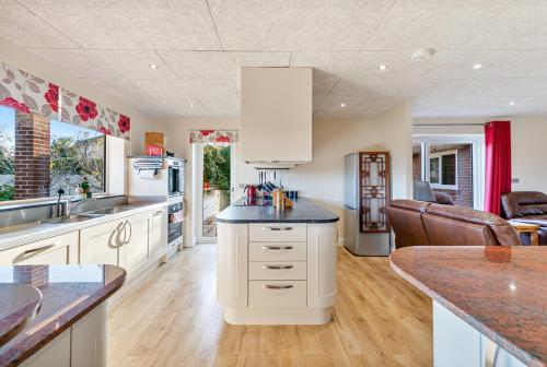 a kitchen with white cabinets and a counter top at Magnificent Getaway - Tennis, Climbing & More! in Backwell