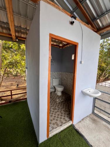 a bathroom with a toilet inside of a house at Modo home in Komodo