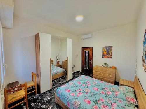 a bedroom with a bed and a mirror at Eden Guesthouse in Bologna