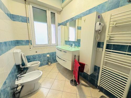 a bathroom with a toilet and a sink at Eden Guesthouse in Bologna