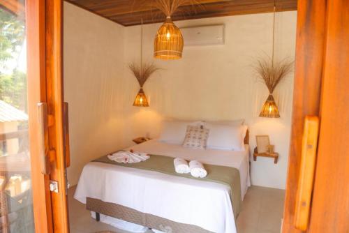 a bedroom with a bed with two towels on it at Villa Loui Beach Icaraizinho-Ce in Icaraí
