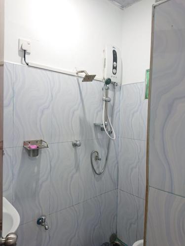 a bathroom with a shower and a toilet at David Villa in Anuradhapura