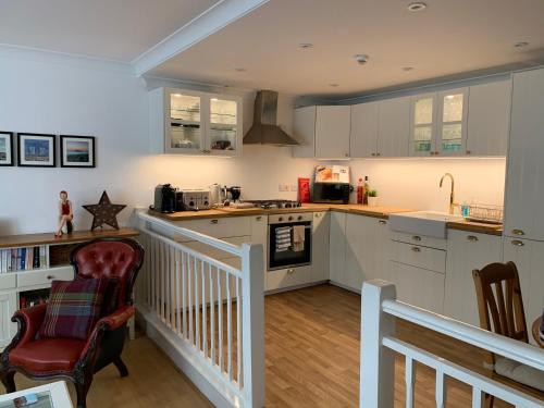 a kitchen with white cabinets and a counter top at Olive Tree Apartment Hove in Brighton & Hove
