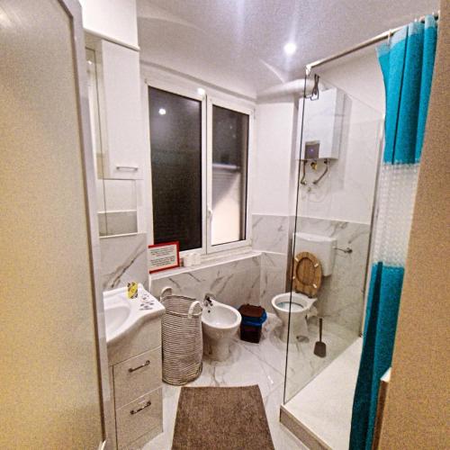 a bathroom with a shower and a sink and a toilet at Dalla Laretta di fronte all Acquario di Genova in Genoa