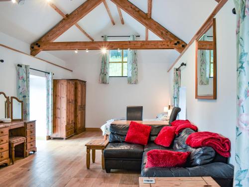 a living room with a leather couch and a table at Slade Cottage - Uk35027 in Highbray