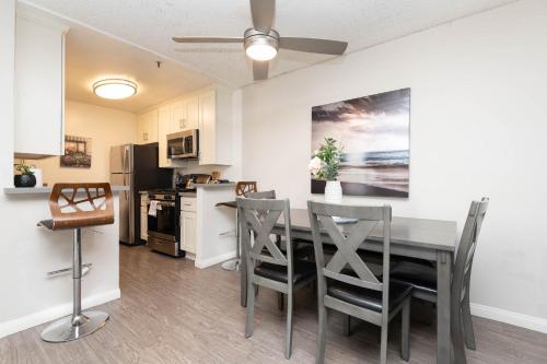 a kitchen and dining room with a table and chairs at Hollywood Luxe 2BR Apartment with Rooftop Pool and Breathtaking Views in Los Angeles
