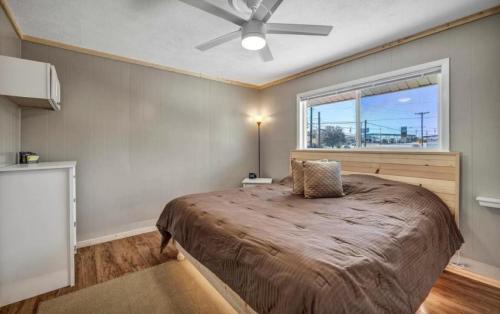 a bedroom with a bed with a ceiling fan and a window at Waterfront Getaway Lake Access Deck BBQ Grill in Kingsland