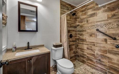 a bathroom with a toilet and a sink and a shower at Waterfront Getaway Lake Access Deck BBQ Grill in Kingsland