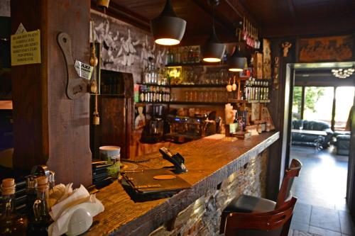 a bar in a restaurant with a counter in a room at Gościniec Salmopolski in Szczyrk
