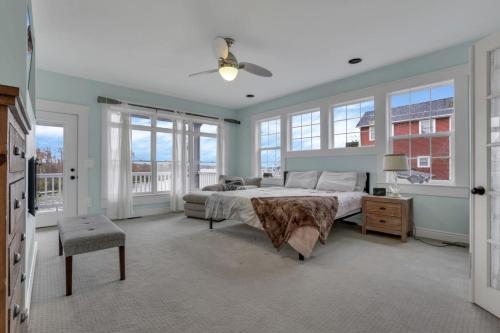a bedroom with a large bed and windows at The Lakehouse in Buckeye Lake