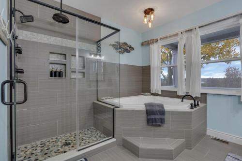 a bathroom with a tub and a glass shower at The Lakehouse in Buckeye Lake