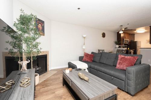 a living room with a couch and a table at 2BR Hollywood Apt with Rooftop Pool & Stunning Views in Los Angeles