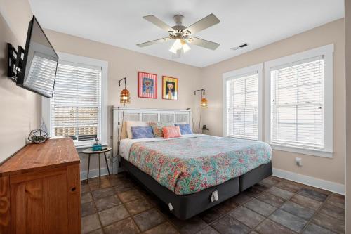a bedroom with a bed and a ceiling fan at After Dune Delight in Kure Beach