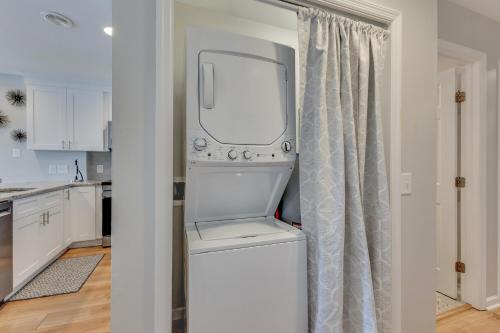 a washer and dryer in a kitchen next to a window at Three Little Birds in Kure Beach