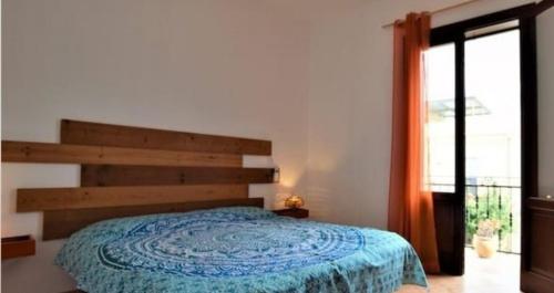 a bedroom with a bed and a large window at Casetta La Meridiana in San Vito lo Capo
