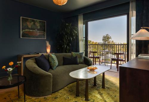a living room with a couch and a table at Hotel Daphne in Houston