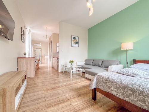 a living room with a bed and a couch at The Lion Rooms in Ustroń
