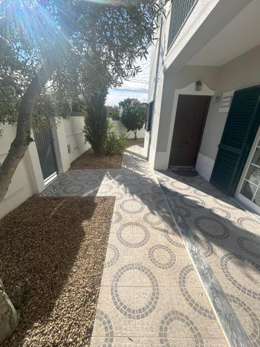 a walkway outside of a house with a tile floor at Casa Luz - Brejos de Azeitão in Azeitao