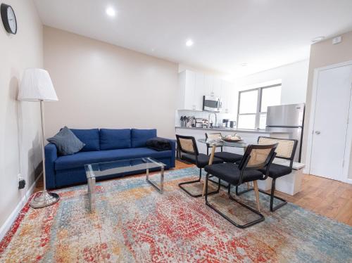 a living room with a blue couch and a table at 3BR apt two blocks to Central Park elevator, laundry, virtual doorman in New York