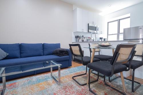 a living room with a blue couch and a table at 3BR apt two blocks to Central Park elevator, laundry, virtual doorman in New York
